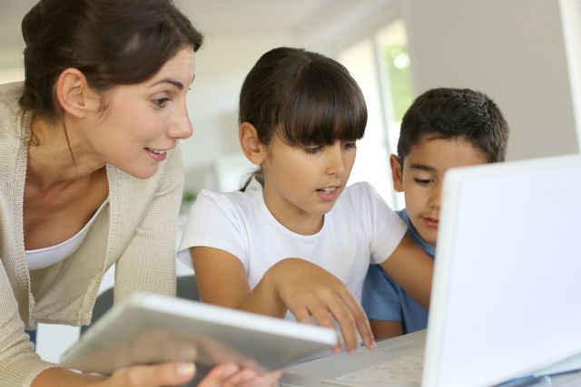 Teacher with students at a computer